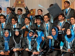 Graduation ceremony of male and female engineers in a ballroom.