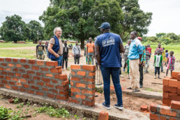 Central African Republic: Project visit and factfinding tour by Dr. Werner Höfner (left, Cap Anamur board member) - here visiting together with Marius Akpe (center, Cap Anamur project coordinator) the Cap Anamur new school construction in Bowesse village.